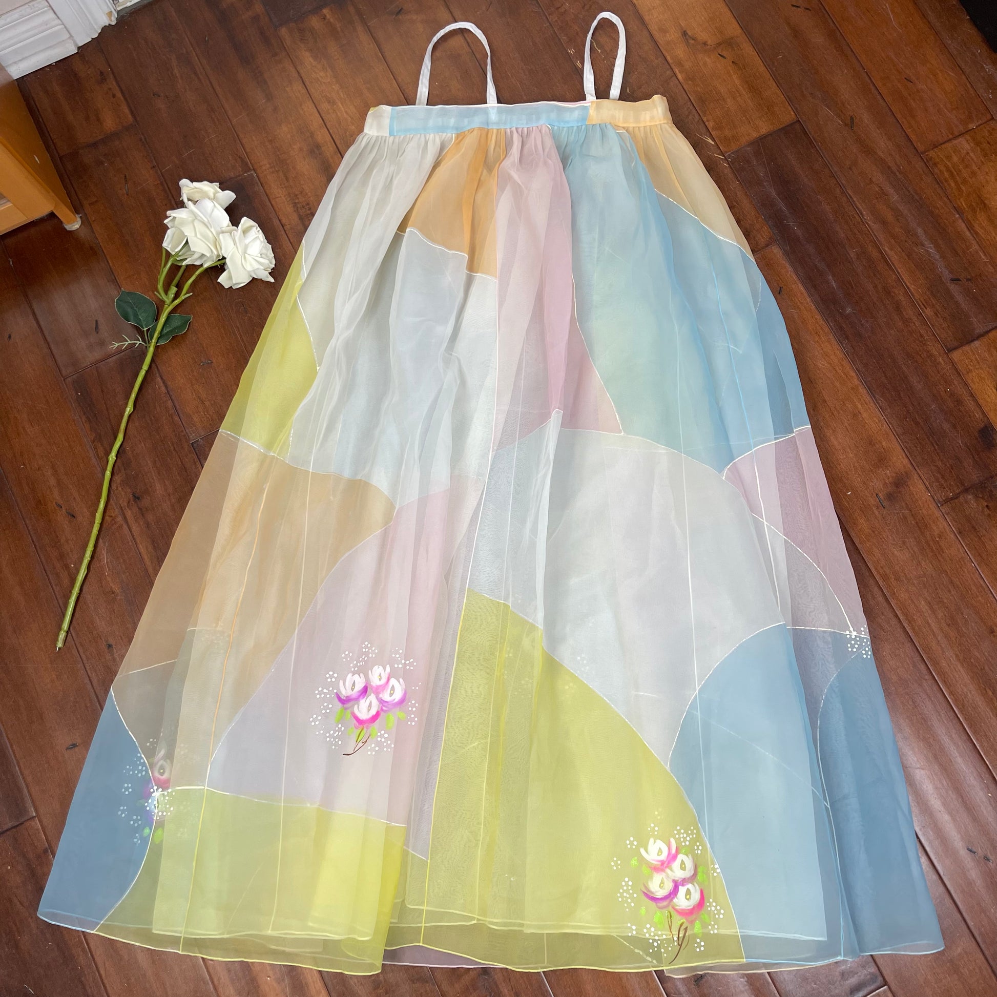 hand painted organza dress Lavender Hand-Painted Organza Dress Set Gracefully ethereal, this lavender organza dress features intricate all-over hand-painted floral designs that evoke a sense of timeless elegance. The airy organza is delicately adorned with botanical